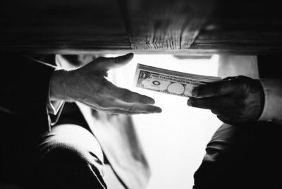 Hands passing money under the table corruption and bribery _ Free Photo